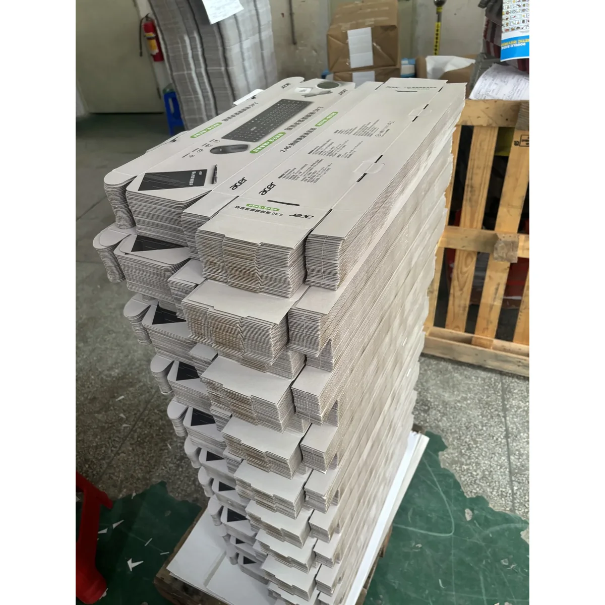 Stacks of flat printed corrugated mailer box blanks
