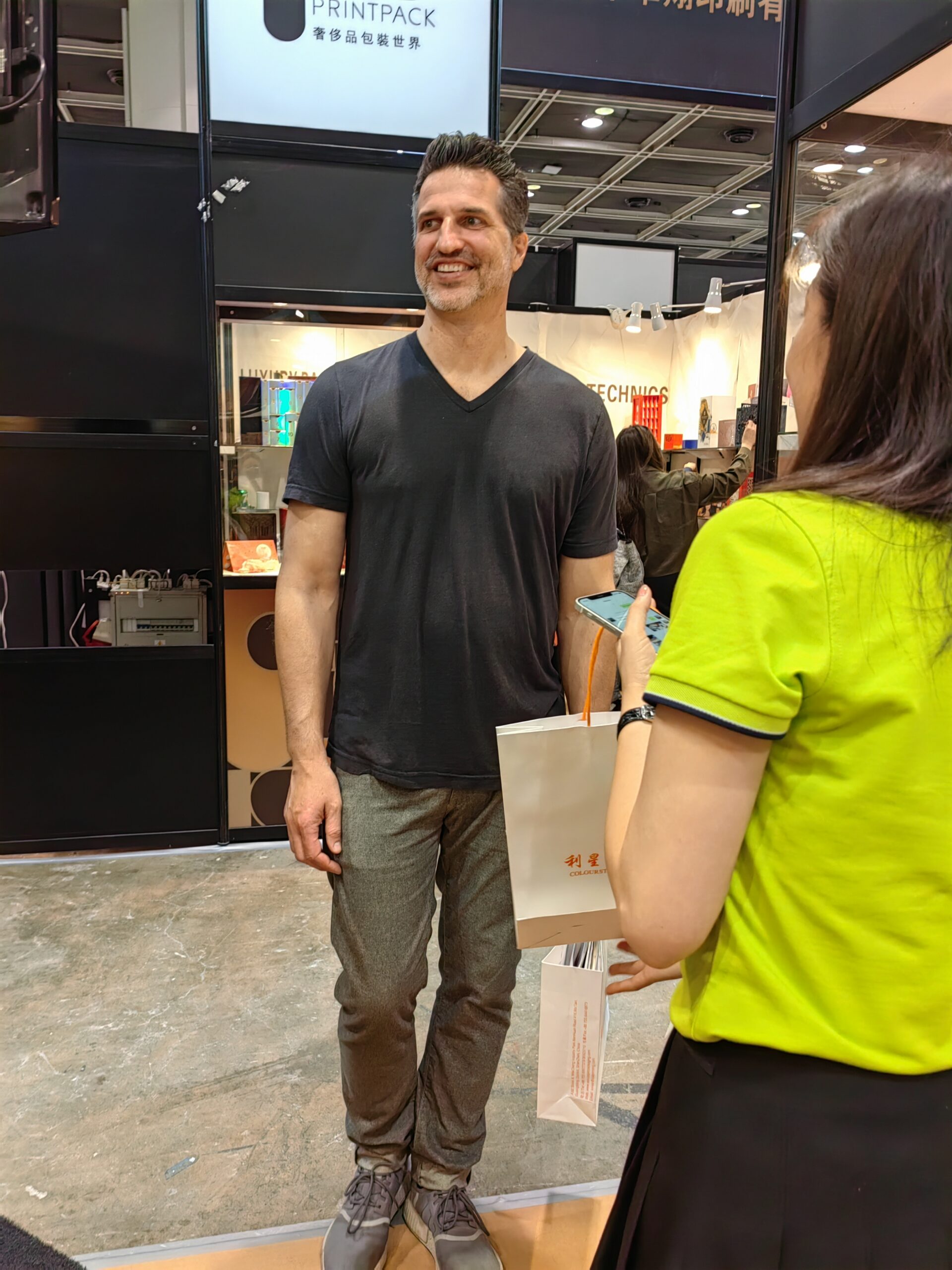 Packaging consultation with a visitor at a trade show booth