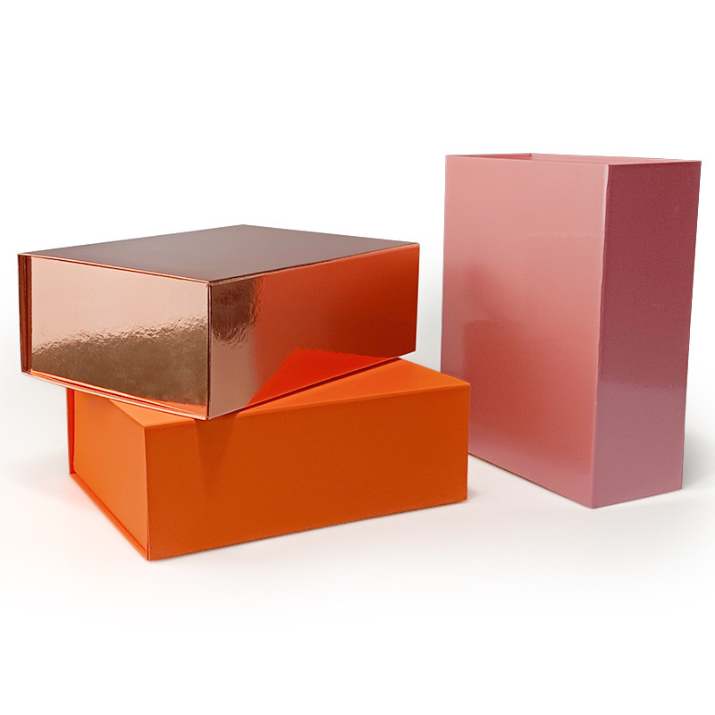 Three assembled foldable rigid boxes in pink, rose gold and orange