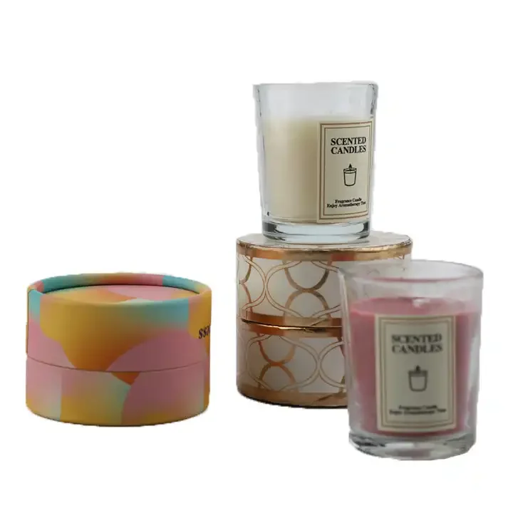 Glass candle jars alongside colorful round paper presentation boxes