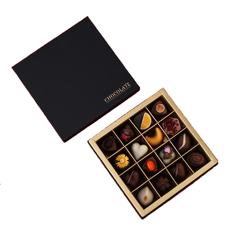 Open divided confectionery gift box with individual chocolate compartments
