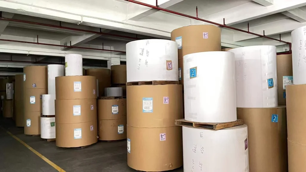 Brown and white rolls of paper stored in a warehouse