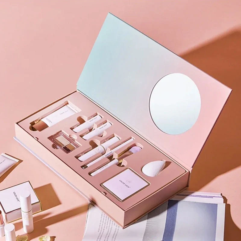 Pink and lilac cosmetics gift box with fitted product inserts and a mirror
