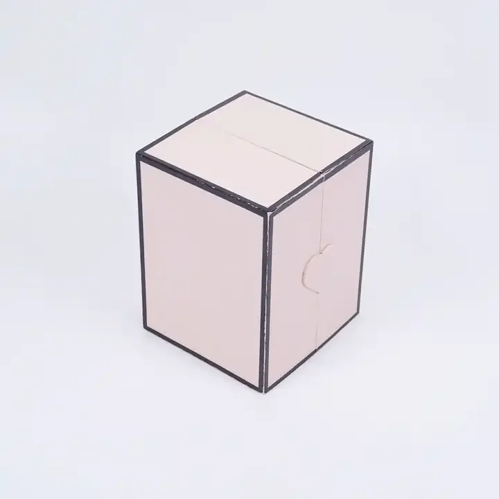 Closed pale pink cube-shaped jewelry presentation box with dark edge trim