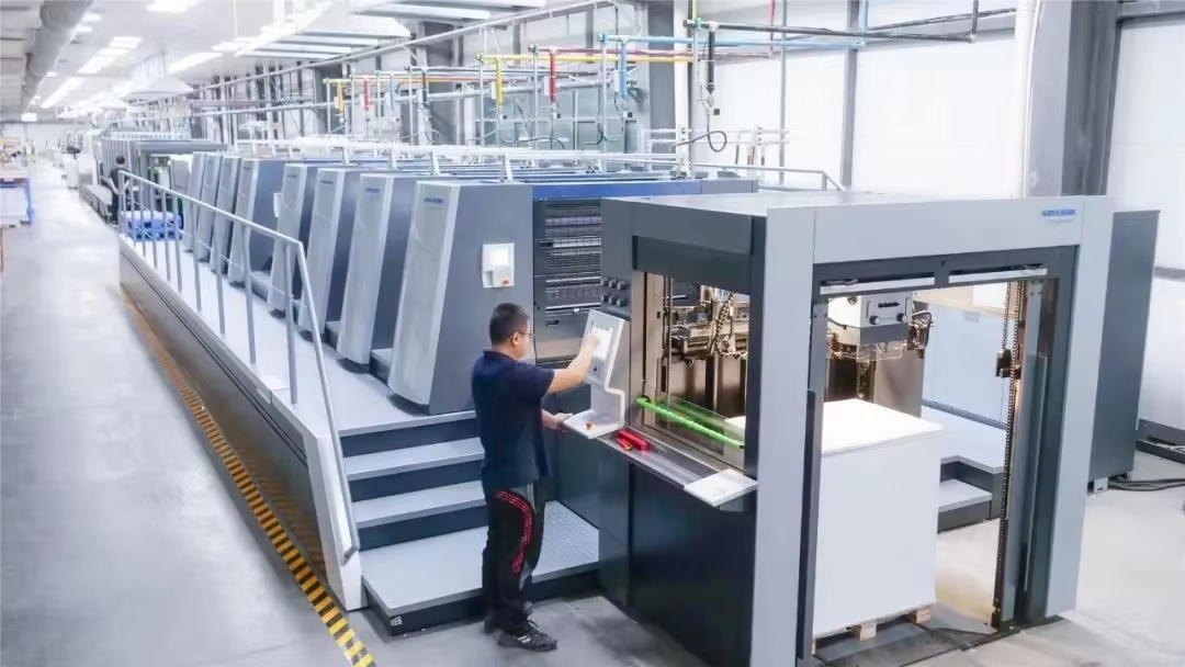 Sheet-fed printing press beside the paper feeder