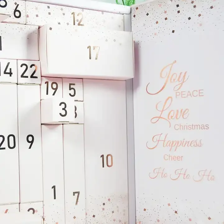 White advent calendar presentation box with numbered compartments and gold details
