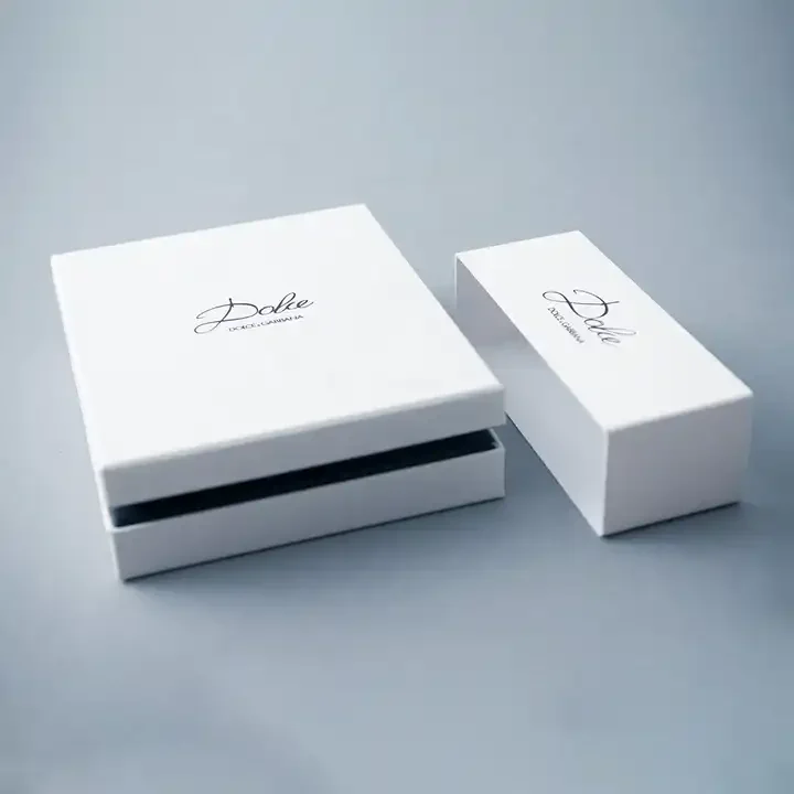 Two white jewelry boxes shown open with dark fitted interiors